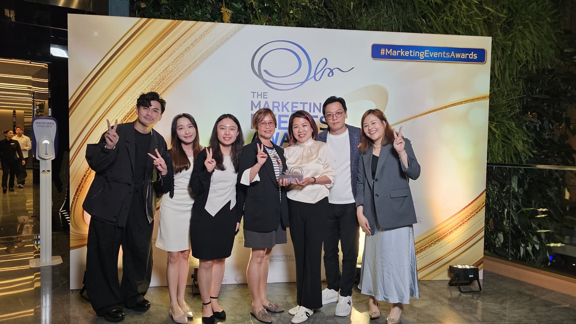 Moxie and Alibaba Cloud team holding the Marketing Events Awards 2026 Best Experiential Event trophy